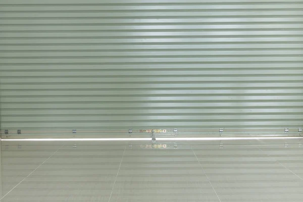 Aluminium steel roller shutter door and tile floor in warehouse