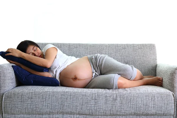 Kvinna gravid sova på soffa möbler i vardagsrummet — Stockfoto