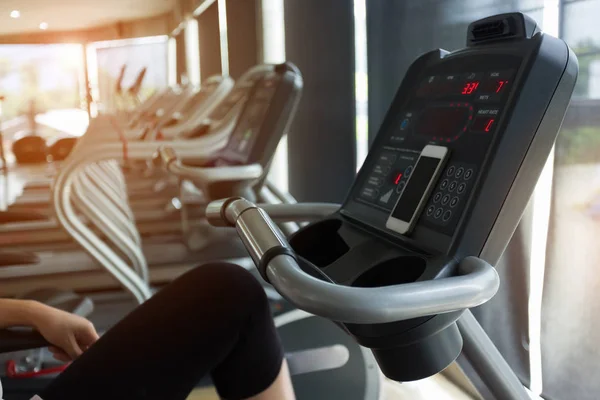 Woman cycling burn fat on bicycle cardio machine in fitness gym — Stock Photo, Image