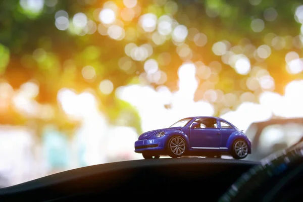 small vehicle car toy in bokeh green nature