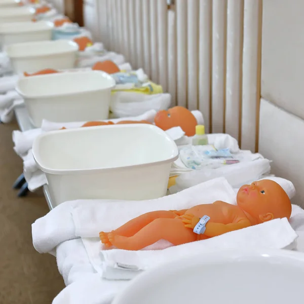 Baby doll in nursery class room with parents training child care — Stock Photo, Image