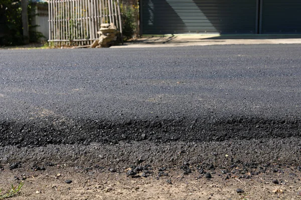 Black asphalt construction road surface level with tarmac — Stock Photo, Image