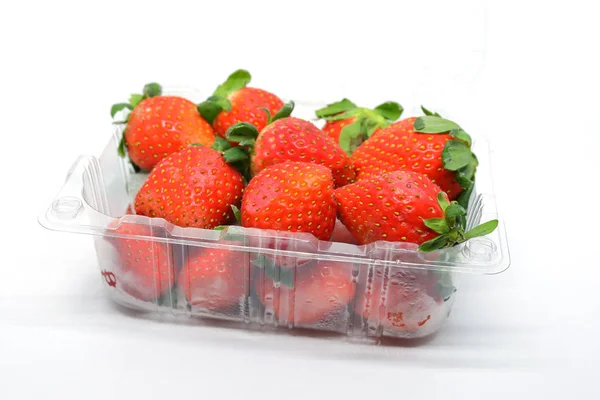 Red strawberry ripe sweet fruit in plastic box packaging, isolat — Stock Photo, Image