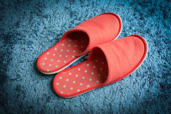 Red slipper shoe on blue carpet floor softness mat — Stock Photo, Image