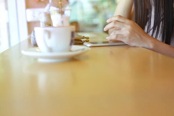 Female using mobile phone in coffee cafe — Stock Photo, Image