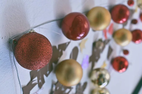 Red glitter christmas ball ornament hanging on wall — Stock Photo, Image