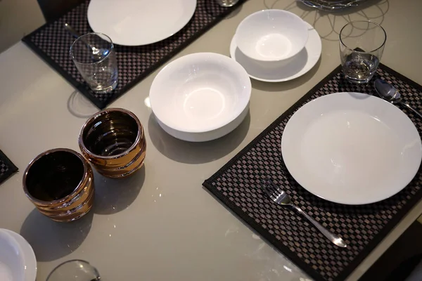 white dish ware sets arrange on dinner table inside eating room