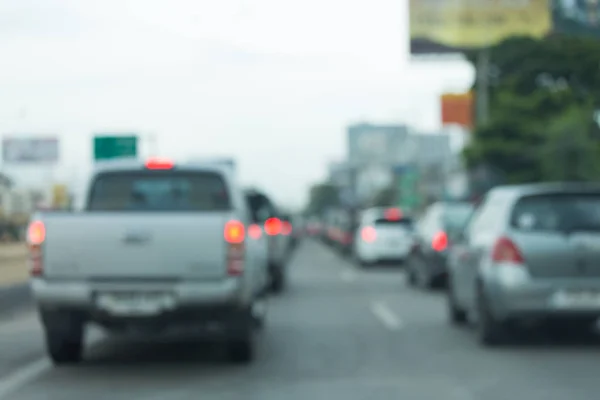 Car driving on urban road, image blur background — Stock Photo, Image