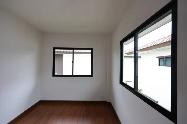 interior design empty white room with glass window and wooden laminate floor of a new residential house