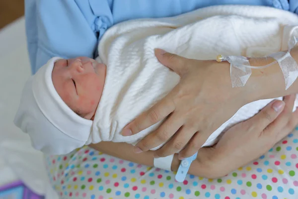 Woman mother holding a baby with feeling love after childbirth newborn in hospital — Stock Photo, Image