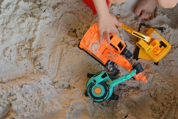 Child boy play construction vehicle toy in sand playground — Stock Photo, Image