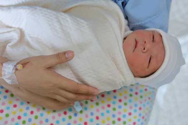 Woman mother holding a baby with feeling love after childbirth newborn in hospital — Stock Photo, Image