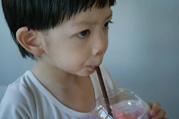 Happy cute boy drink strawberry smoothie fruit — 스톡 사진