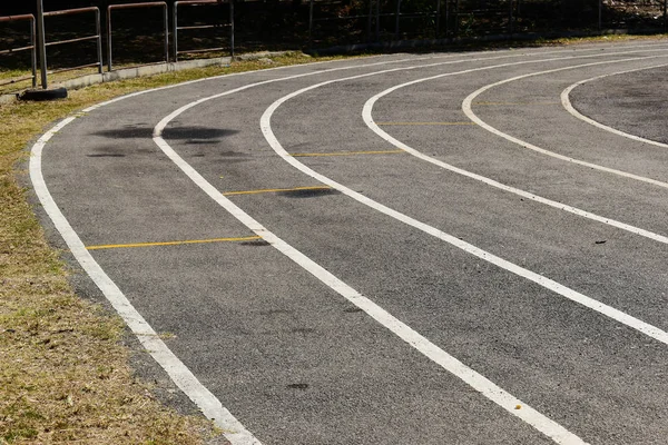 Black tarmac asphalt of running track, athletic sport background — 스톡 사진