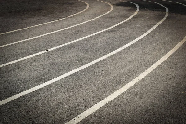 Black tarmac asphalt of running track, athletic sport background — 스톡 사진