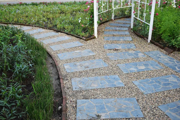 Stone block pathway in flower garden — 스톡 사진