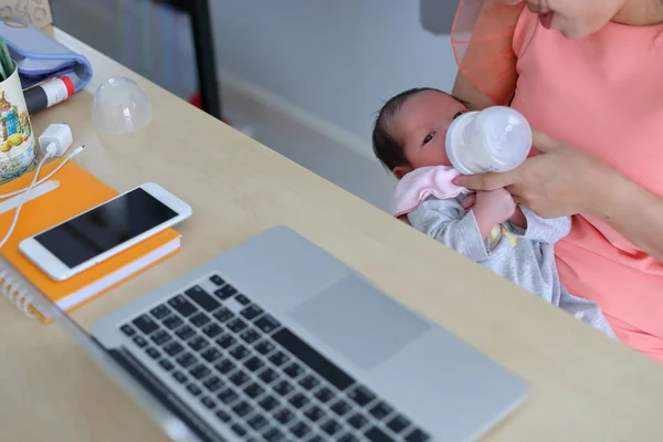 businesswoman parenting a little her son in business home office