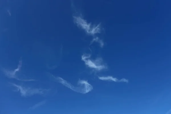 Mavi gökyüzünde beyaz bulutlu boru şeklinde sigara ve duman — Stok fotoğraf