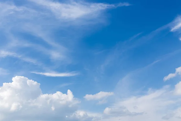 fluffy white cloud moving above clear blue sky