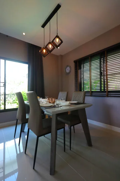 dish ware sets arrange on dining table inside eating room of modern home interior