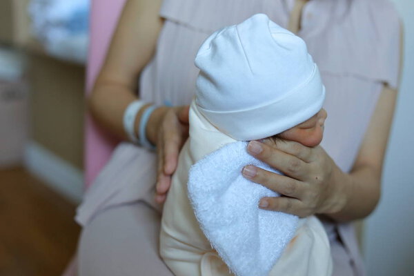 mother parenting, mom using hand help a baby newborn belch burping after breastfeeding milk