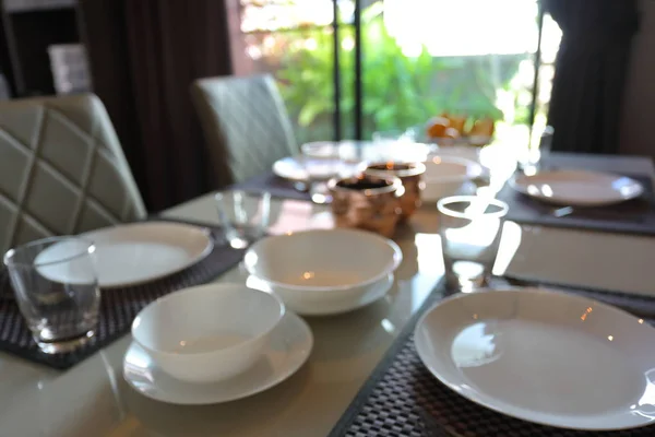 dish ware sets arrange on dining table inside eating room of home