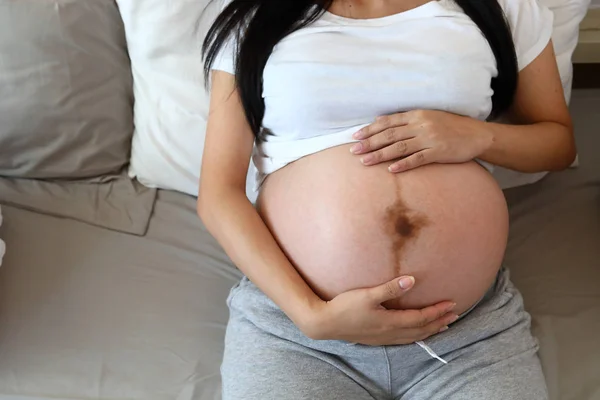 Matka trzymać ręce obejmując brzuch w ciąży z miłości do dziecka — Zdjęcie stockowe