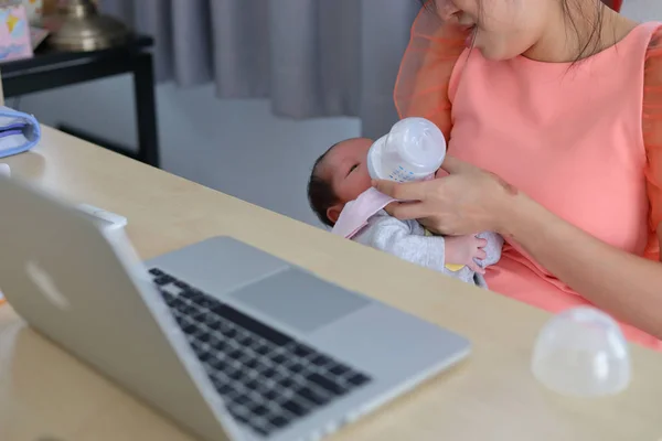 businesswoman parenting a little her son in business home office