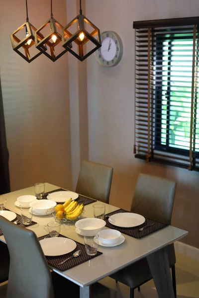 食器セットはモダンホームインテリアの食堂内のダイニングテーブルに並べ — ストック写真