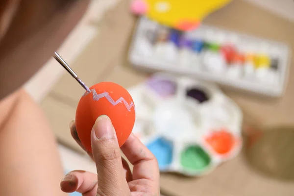 people painting easter egg custom pattern design with watercolor