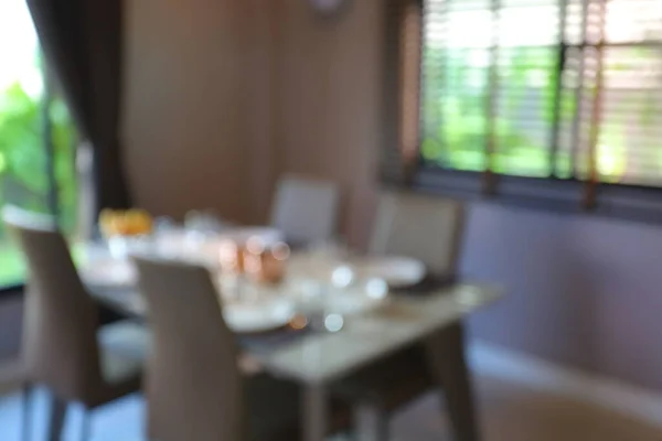 dish ware sets arrange on dining table inside eating room of home, image blur background