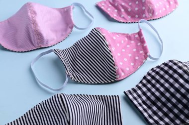 düz dizayn siyah ve pembe renkli moda yüz maskesi kumaştan el yapımı mavi arka plan