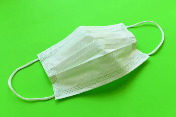 medical hygiene face mask on green background