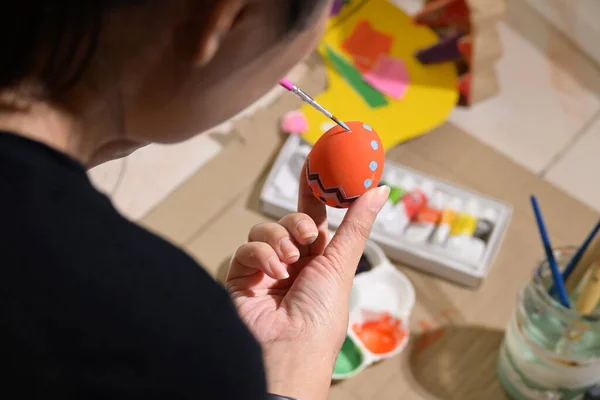 people painting easter egg custom pattern design with watercolor