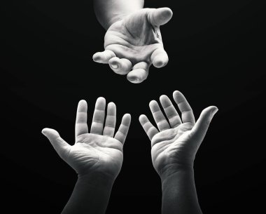 International migrants day concept: Black and white child reaching two hand to God on dark room background. clipart