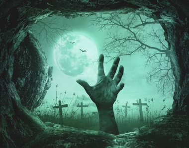 Korkunç elinde mağara ürpertici mezarlığı arka plan ile ölüm ağacı üzerinde bir taş üzerinde.