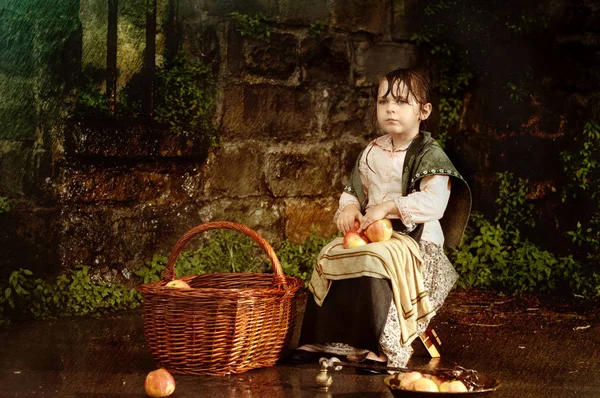 Klein meisje met een mand van appels — Stockfoto