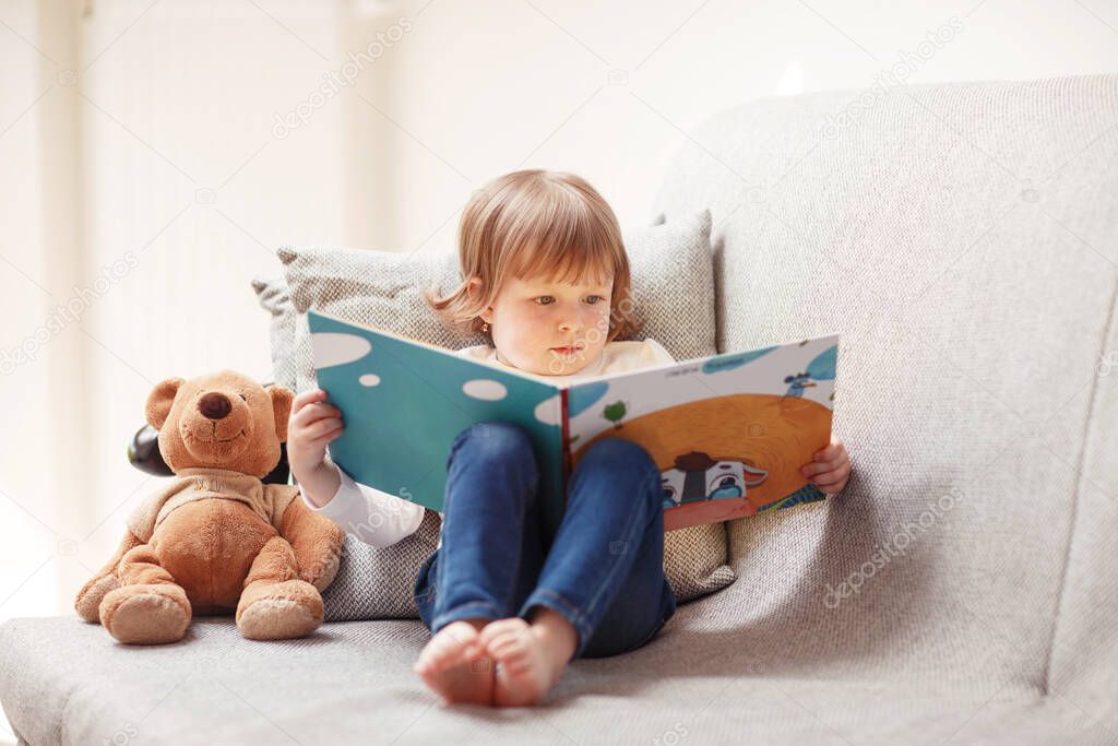 Kid with book at home