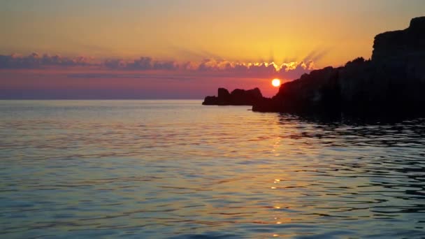 Sonnenuntergang über dem Meer mit Felsen und Wolken Zeitlupe — Stockvideo