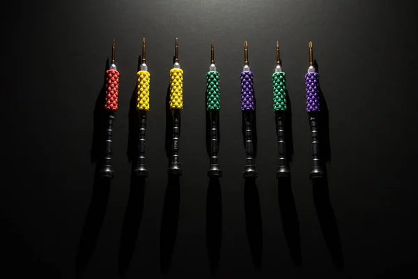 a set of colored small screwdrivers for electronics repair: phones, laptops, computers, tablets