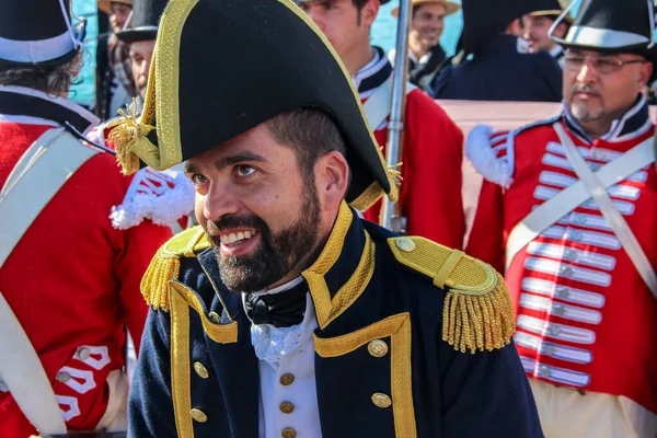 Malaga, İspanya - 26 Ekim 2014: 1800 'lerin Kraliyet Donanması kaptanı portresi. İngiliz üniforması, mavi frak ve bicorn şapka giyiyor. Kraliyet Donanması üniformalı adamlar arkada..