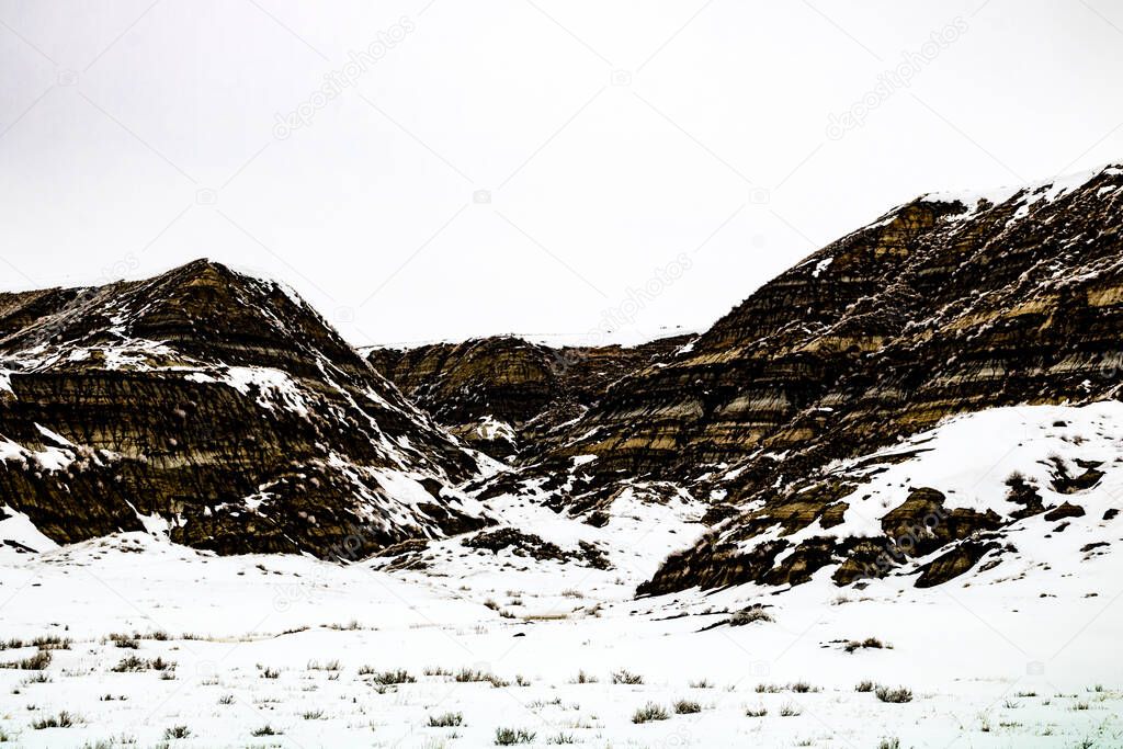 Snow clings to the hills and valleys of the badlands. Drumheller Alberta, Canada.