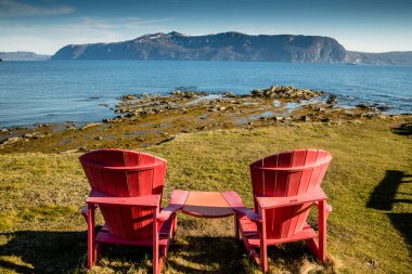 Red chairs and view from Yellow Point. Gros Morne National Park, Newfoundland, Canada clipart