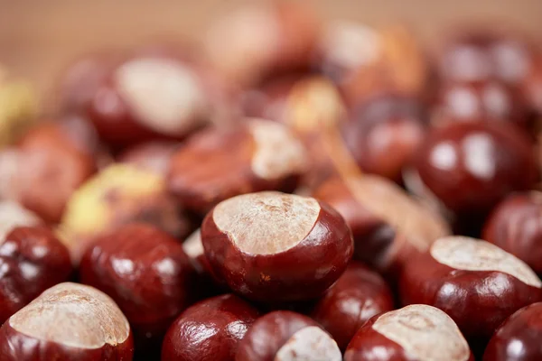 Chestnuts on a wooden table as autumn background — Stock Photo, Image