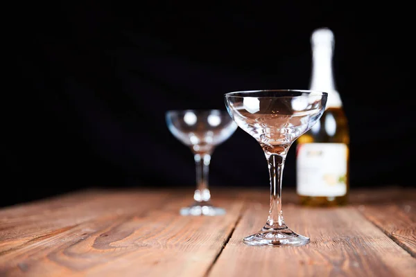 Champagne glasses and bottle on table — Stock Photo, Image