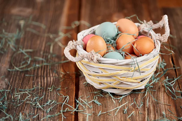 Easter basket with colored easter eggs — Stock Photo, Image
