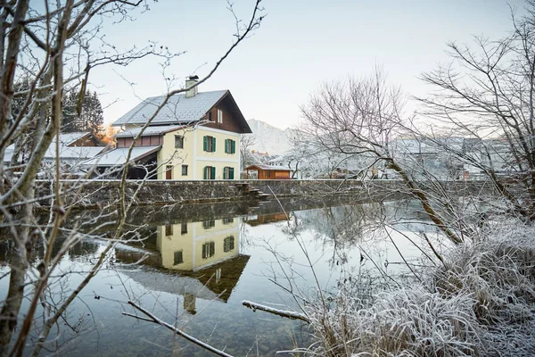 House at the river with frost and ice