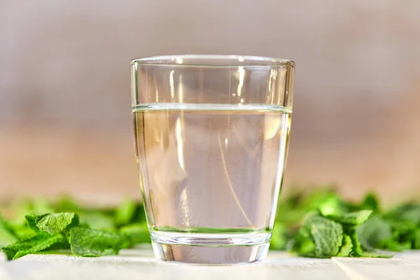 Fresh glass of water with mint on table — Stock Photo, Image