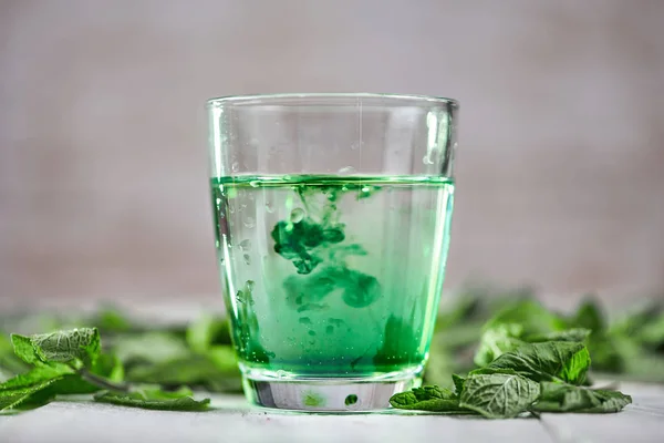 Chlorophyll in glass of water with fresh green mint Stock Photo