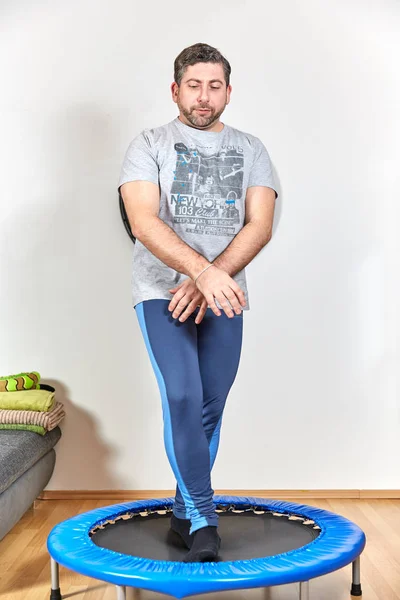 Caucasian man doing fitness exercises at home